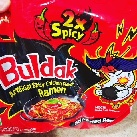 Image of spicy ramen Buldak with spicy chicken and text 2x spicy